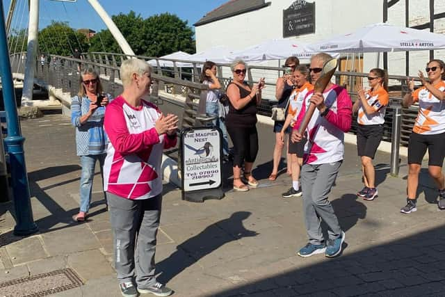 Peter hands over the baton to Linda in Church Street.