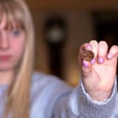 Grace McLain of Dugglebys with the rare 2,000-year-old coin, minted in Sleaford and found by a detectorist in East Yorkshire. Photo: Newman Walker