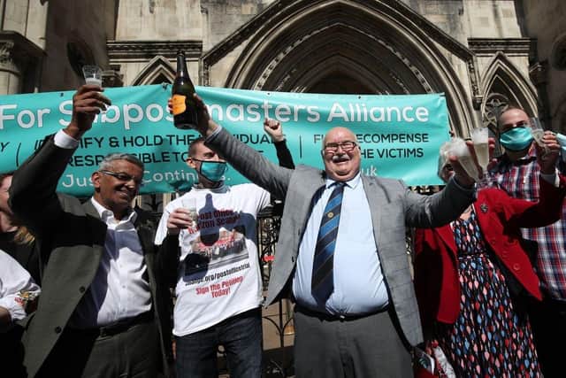 Tom Hedges outside the Appeal Court with the botle of Prosecco bought for him by his 93-year-old mother after his conviction was overturned.