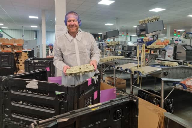 CEO Daniel Fairburn on the production line packing eggs.
