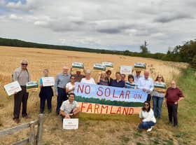 The campaign group with Coun William Gray (third left) and Sir Edward Leigh (fourth right) at the site of the proposed solar farm.