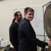 Jason Easterling of Green Man Gongs lets Year 11 St George's student James Snowball have a go at the careers fair.
