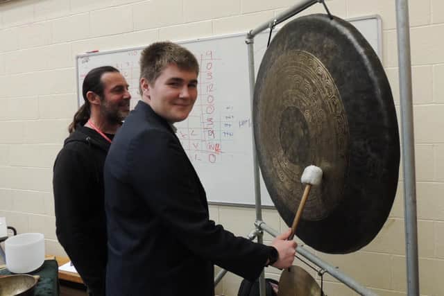 Jason Easterling of Green Man Gongs lets Year 11 St George's student James Snowball have a go at the careers fair.