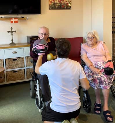 Bailey Greetham-Clark from BeGreat Fitness runs sessions with Tanglewood Care Home residents Arthur and Olive.