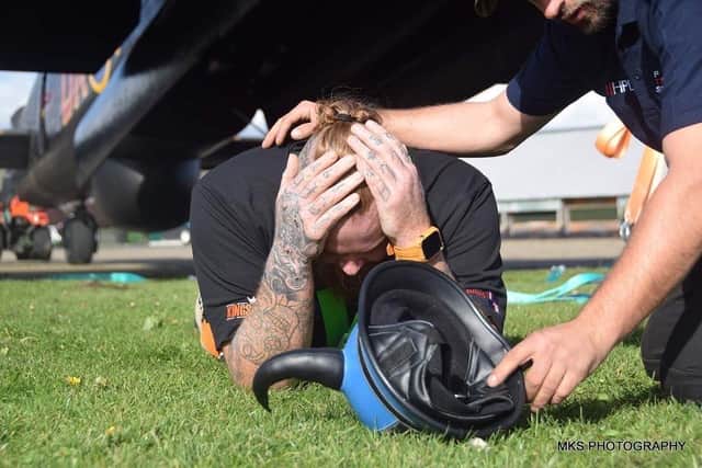 Ryan collapses after completing the challenge at Lincs Aviation Heritage Centre.