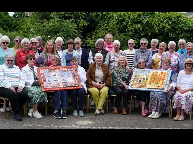 Members of the Boston Stitchers with two of the books set to go on show at Fydell House.