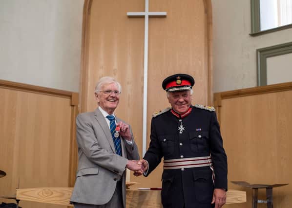 Peter Maddison receives his medal Lord Lieutenant of Lincolnshire Toby Dennis. Photo: Holly Parkinson