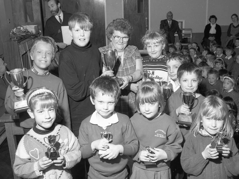 Pupils at Butterwick School receiving their end-of-term prizes from retiring caretaker Muriel Tempest.