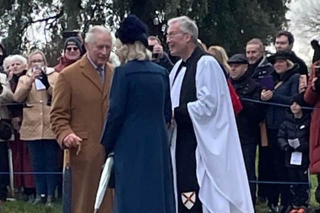 Reverend Canon Dr Paul Rhys Williams greets the King and Queen Consort at Sandringham.