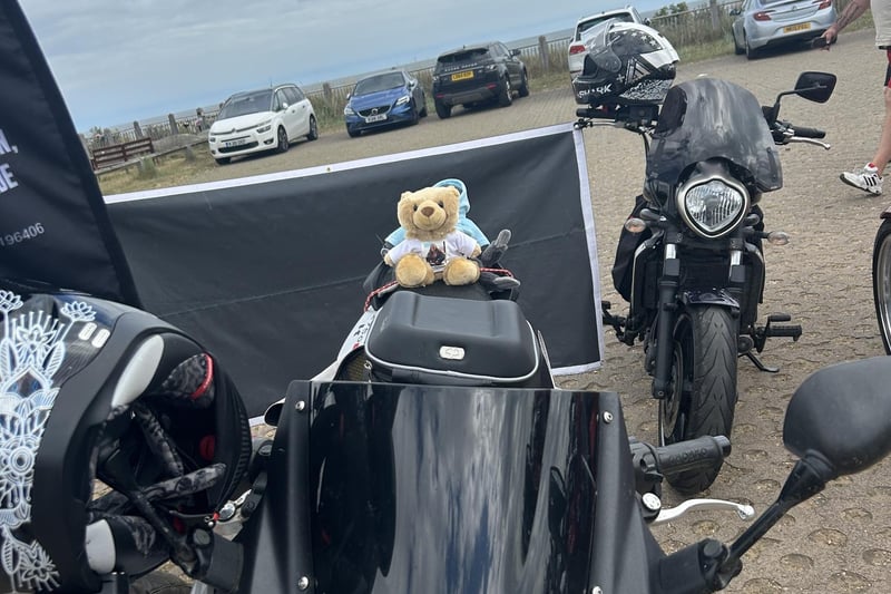 Kibi Bear strapped to the pillion of one of the bikes.