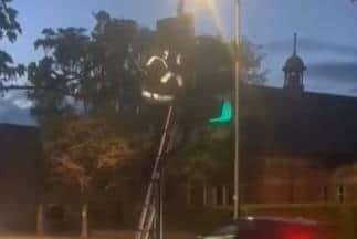 A vandal caught on camera in action cutting sensor wires on a set of traffic lights in Sleaford. Photo: LCC