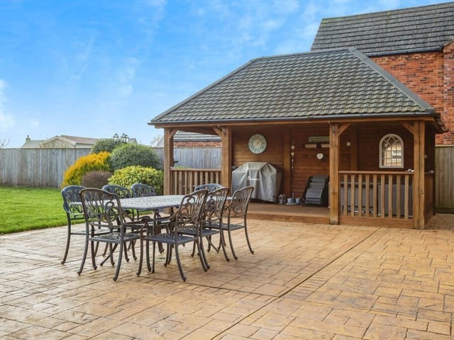 The patio and covered seating area to the rear of the home.