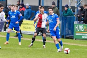Action from Trinity's FA Trophy exit to Woking on Saturday.