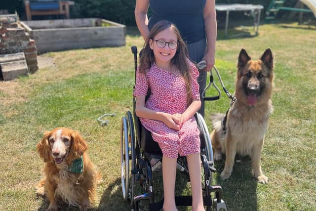 Phoebe with her mum Rebecca and dogs Chief (left) and Clio (right).