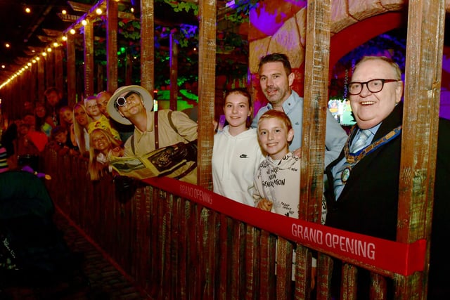 All aboard - families queue for the Harrington Flint's Island Adventure ride with Harrington Flint, Fantasy Island owner James Mellors, his children Lacey and Archie and acting chair of Ingoldmells Parish Council Coun Leonard Hemingway.