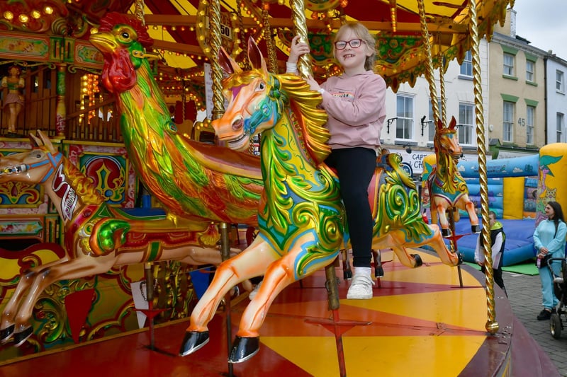 Ruby Tomlin, 7, of Boston has a go on the Galloping Horses ride.