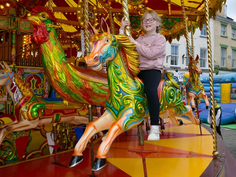 Ruby Tomlin, 7, of Boston has a go on the Galloping Horses ride.