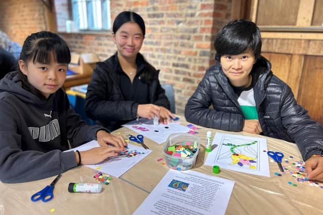 Wendy Cao and her children Ella He and Yuki He loved helping to create the mosaic