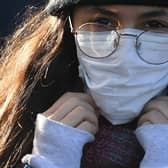 A woman wears a protective face mask in London.  (Photo: Getty).