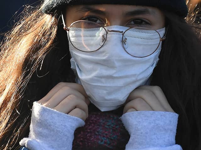 A woman wears a protective face mask in London.  (Photo: Getty).