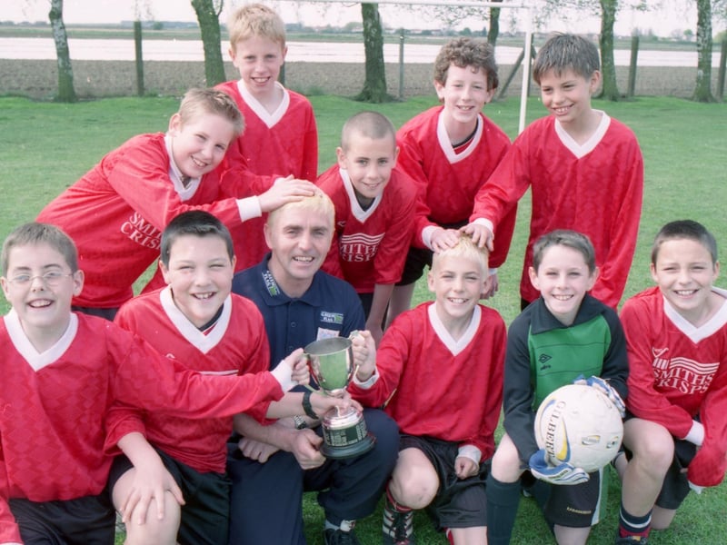 Boston's Hawthorn Tree School celebrating their win in the inter-schools Woodthorpe Cup final. Coach Andy Ogden and his son and team member Liam said they would dye their hair blond if their team were crowned champions. Andy was a member of the Staniland school team who lifted the same trophy 31 years earlier.
