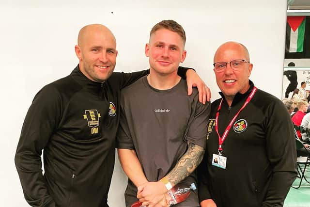 Logan Hare with coaches Dennis Watson and Mark Crozier.
