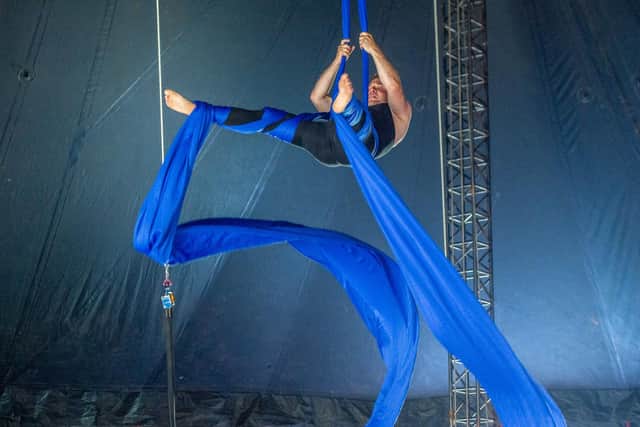 Adam Osborn performing on silks.