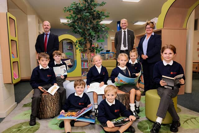 1) Pupils in the new library with (back, left to right) chair of governors Dr Matt Dunn, LGAT Chief Executive Officer Martin Brown and Principal Susan Cook.