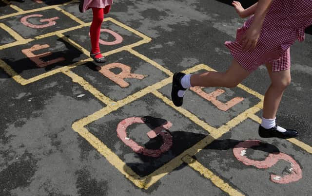 Children at St. George's C of E Primary School in Stockport,play hop scotch during playtime.
