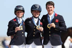 ​Ros Canter, left, with Laura Collett and Tom McEwen on the gold medal podium. Photo: Kevin C. Cox/Getty Images