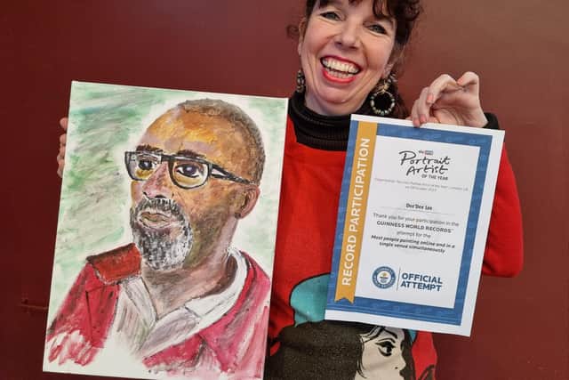 Dee'Dee Lee  woth her portrait of Sir Leny Henry and her world record certificate.