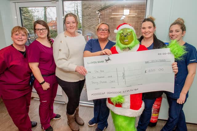 Sarah Drage, the Ark's Kennel supervisor, receives the cheque from Clare Pennell at Black Sheep Vets in Louth.