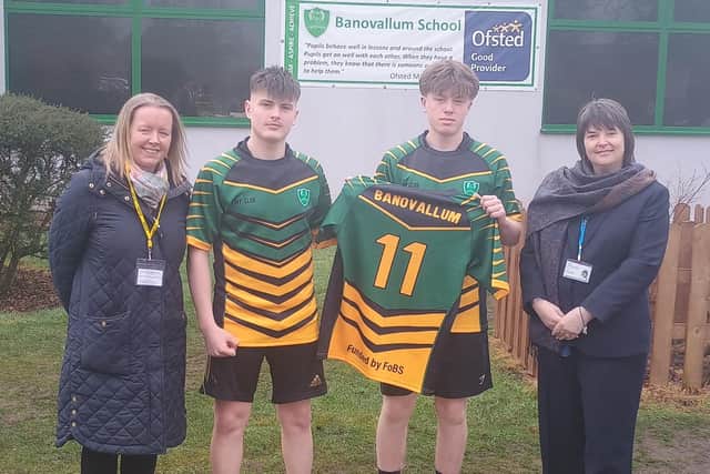Team captain Kian Curtis and vice-captain Alfie Walsh show off one of the rugby tour shirts. They are flanked by Nicola Powell (left), chair of the Friends of Banovallum School, and Sandra James, chief executive officer of Horncastle Education Trust. (PHOTO BY: Banovallum School)