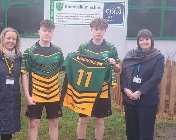 Team captain Kian Curtis and vice-captain Alfie Walsh show off one of the rugby tour shirts. They are flanked by Nicola Powell (left), chair of the Friends of Banovallum School, and Sandra James, chief executive officer of Horncastle Education Trust. (PHOTO BY: Banovallum School)