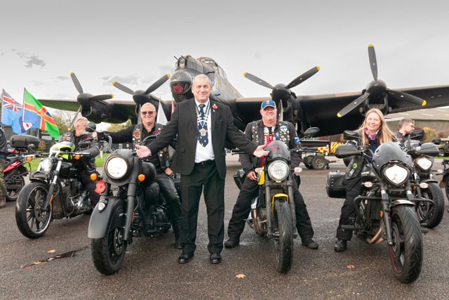 Royal British Legion Chairman John Johnson in front of Lancaster NX611 "Just Jane" at East Kirkby with veterans in the riders' branch.