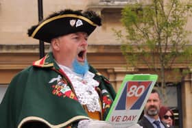 Sleaford Town Crier John Griffiths reads out the VE Day proclamation.