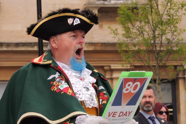 Sleaford Town Crier John Griffiths reads out the VE Day proclamation.