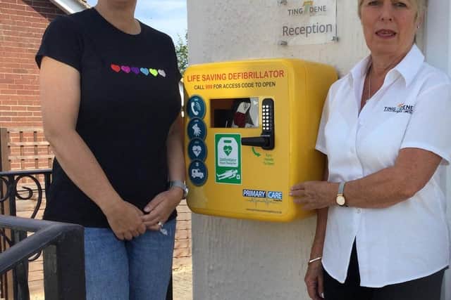 Caroline Dawson with Wendy Kalra of Ting Dene with the new defibrillator.