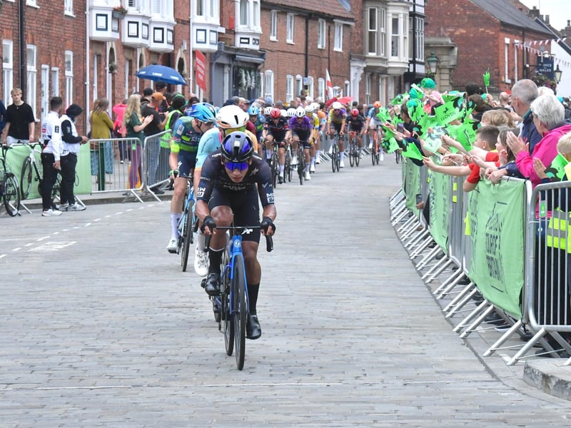 Riders power over the city's cobbles to the first stage finish in Lincoln.