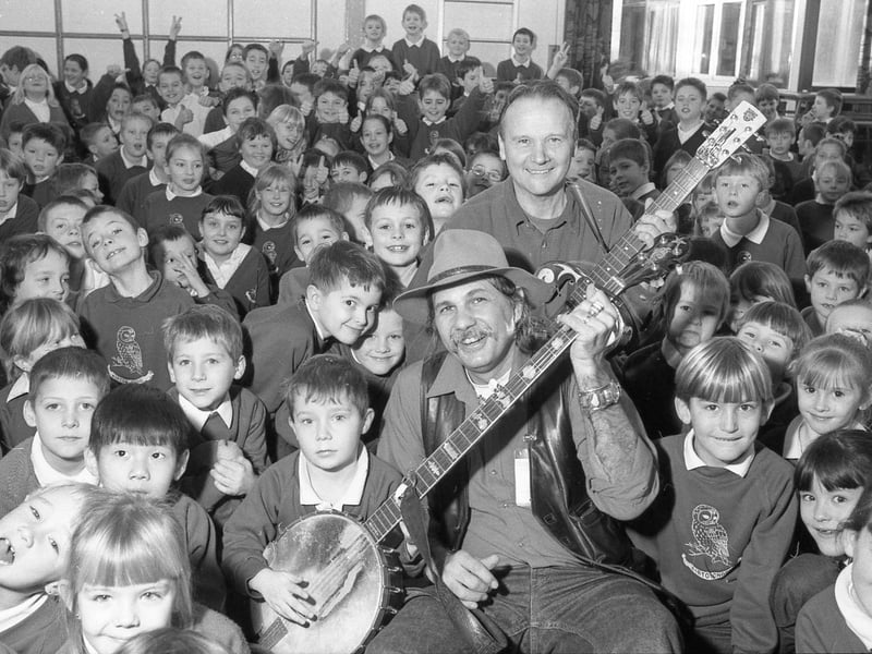 Kirton Primary School playing host to American country folk musicians Rik Paliesi (front) and Gareth Hedges. The duo took time to entertain the youngsters as part of a current world tour.