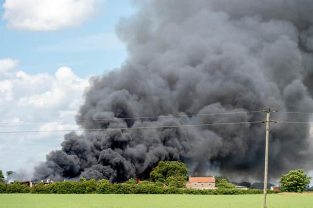 The fire caused a huge plume of thick black smoke to rise into the air - with nearby neighbours advised to close their windows and doors.