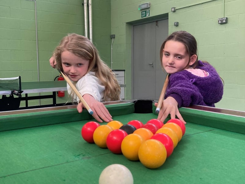 Children playing pool in the centre.