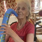 This Tanglewood resident joins in the fun of the festival by playing a plastic saxophone.