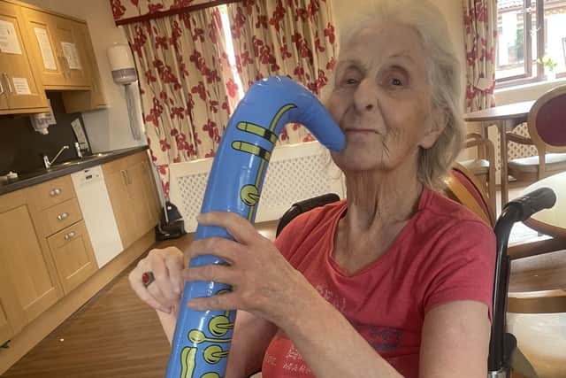 This Tanglewood resident joins in the fun of the festival by playing a plastic saxophone.