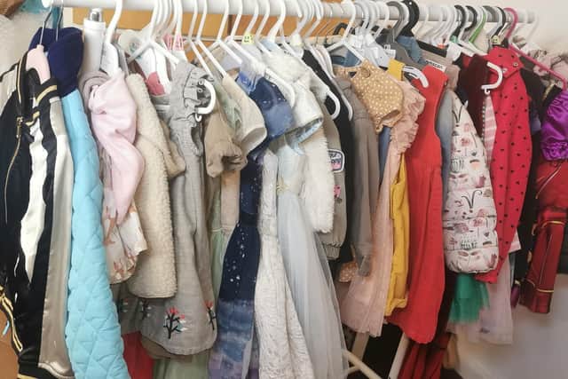 A clothes rail of winter coats and occasion dresses set for the sale, may of which are from Next.
