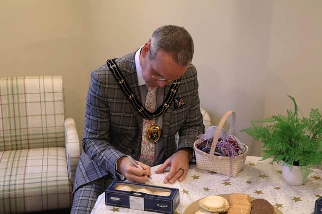 Louth Mayor writing a message for the memorial tree