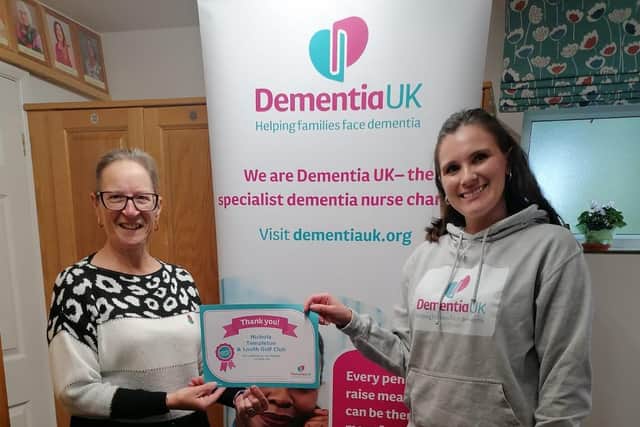 Rachel Carmen from Dementia UK (right) receives a cheque from Nichola Templeton.