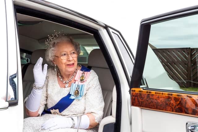 Her Majesty's look-a-like arrives in style to take a tour of the "royal" caravan.