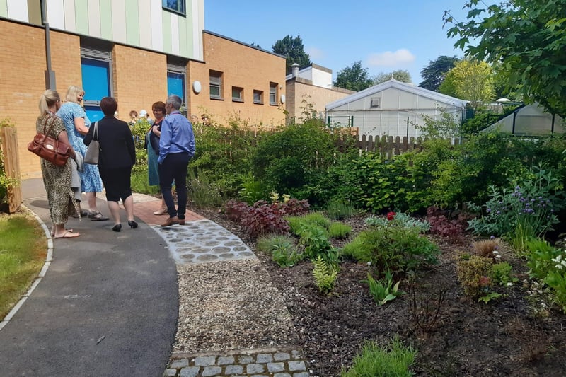 Guests tour the new facilities, including the sensory garden.