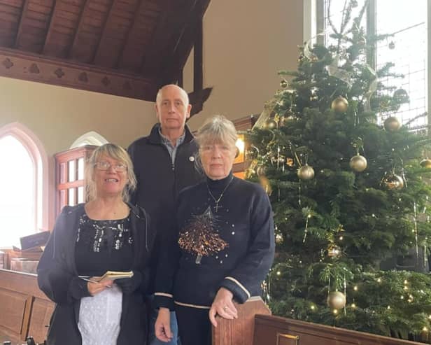 Pastor Susan Alldread (right) with the Dobbies' donation for the Wainfleet Methodist Church Christmas Tree Festival and community meal.
